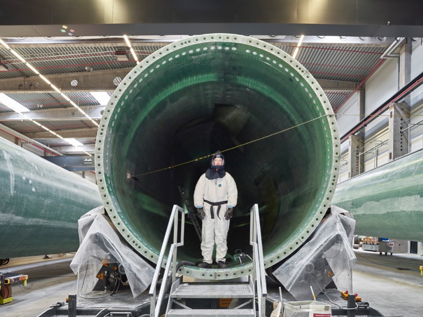 A worker assembling a wind turbine blade, Denmark.